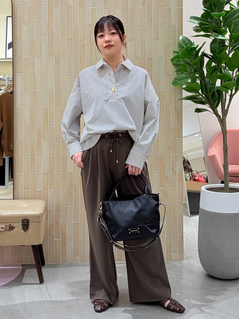 ブラウン系のその他パンツ、ブラウン系のシャツ/ブラウス、ブラック系のショルダーバッグを着用したレディースの春コーディネートの1枚目の写真