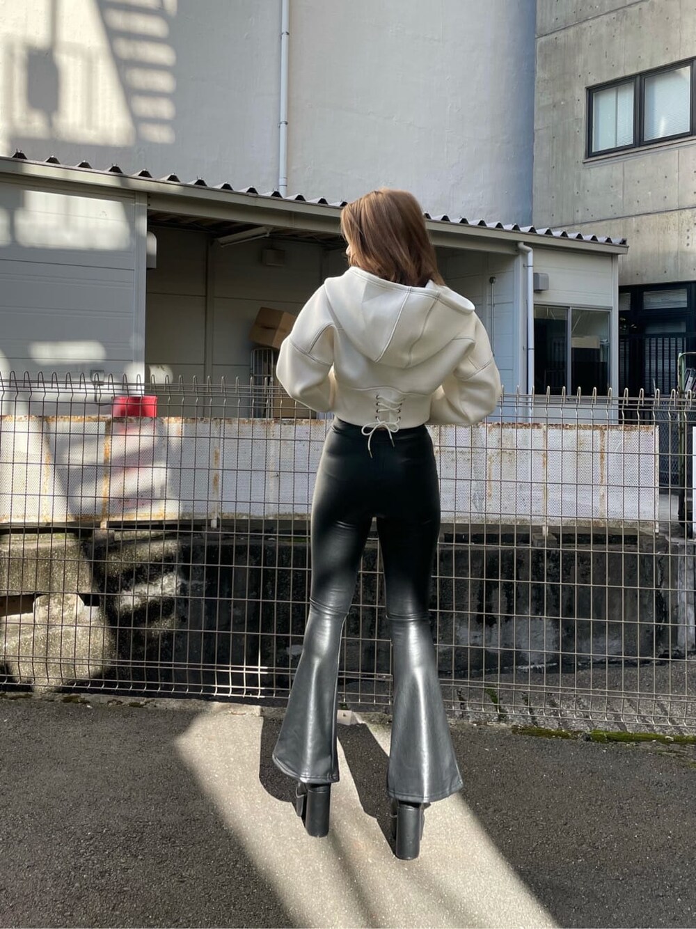 ブラック系のブーツ、ホワイト系のパーカー、ブラック系のその他パンツを着用したレディースの秋コーディネートの1枚目の写真