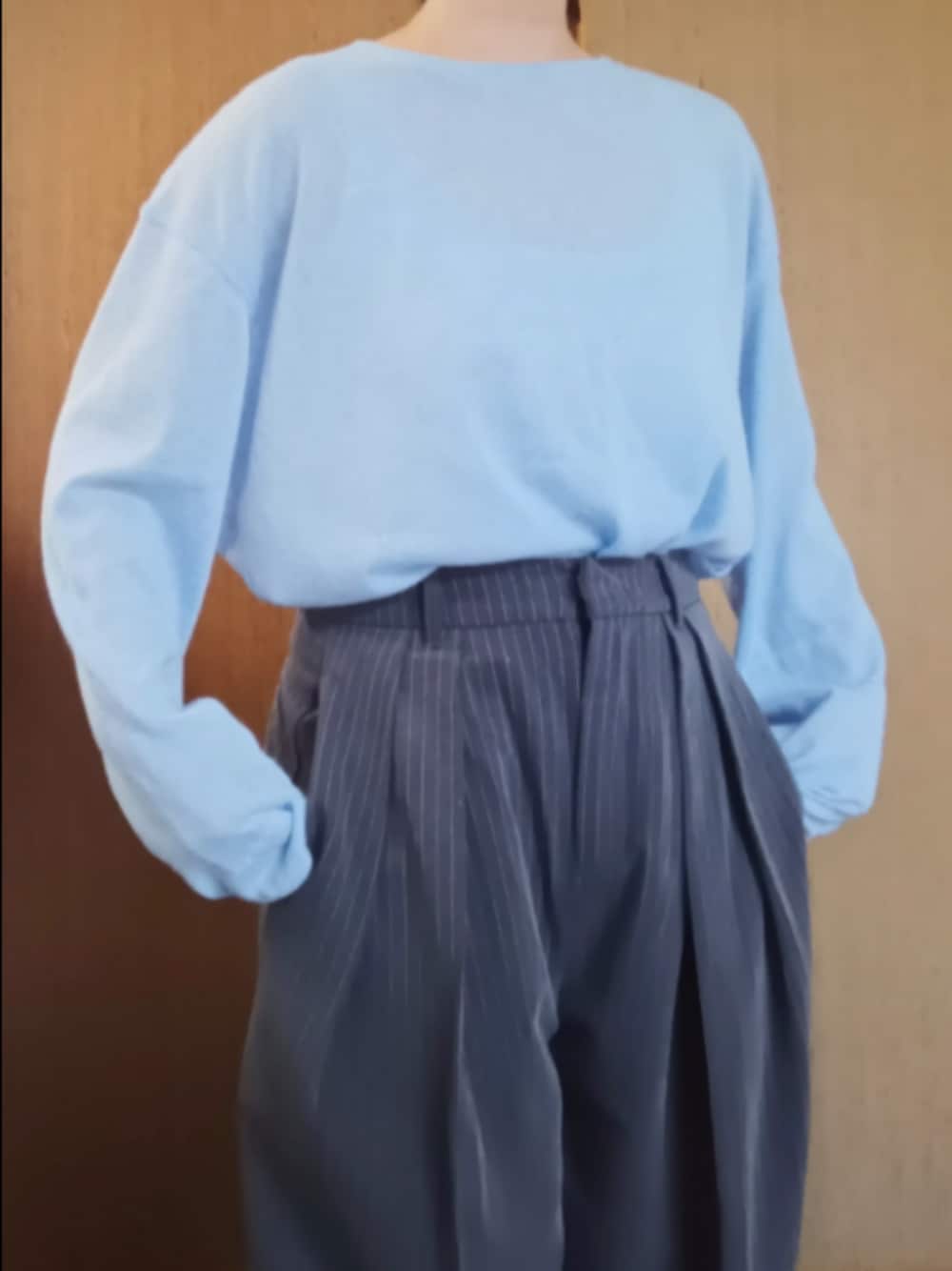 ブルー系のTシャツ/カットソー、グレー系のスラックスを着用したレディースの秋コーディネートの1枚目の写真