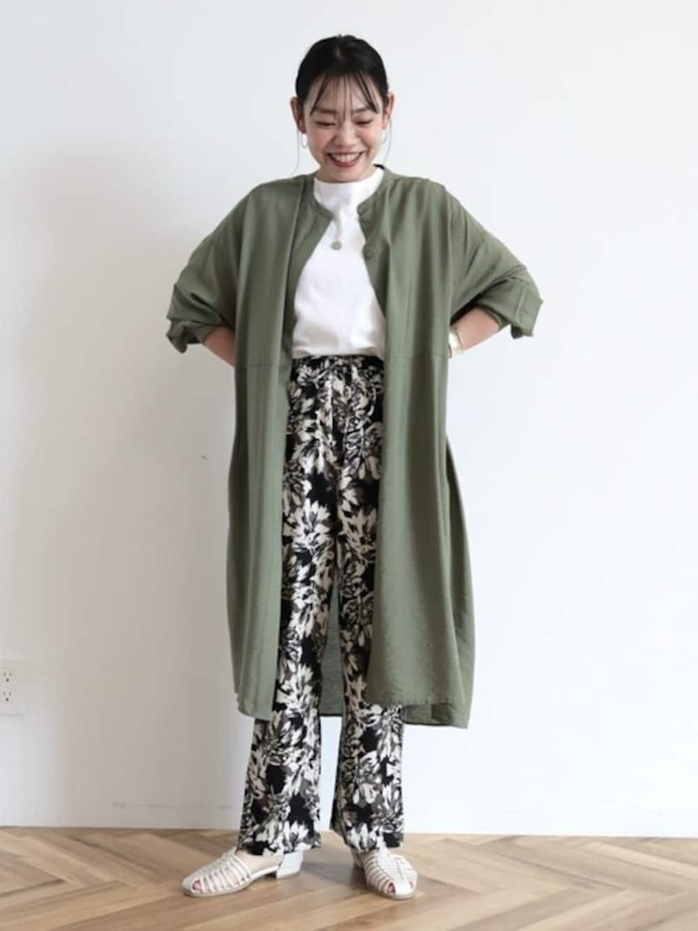 グリーン系のシャツワンピース、ブラック系のその他パンツ、ホワイト系のTシャツ/カットソーを着用したレディースの春コーディネートの1枚目の写真