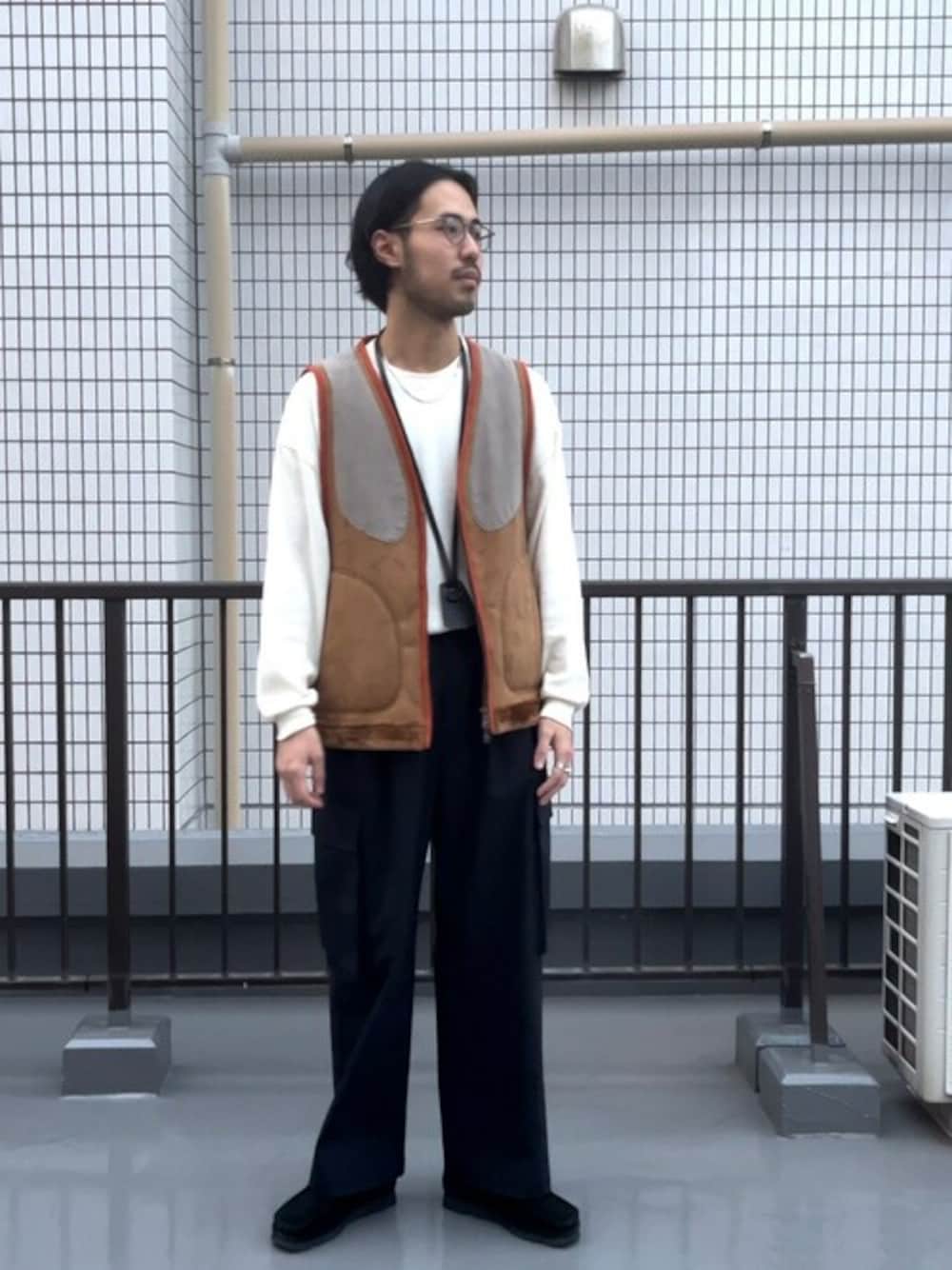 ベージュ系のベストを着用したメンズの秋コーディネートの1枚目の写真
