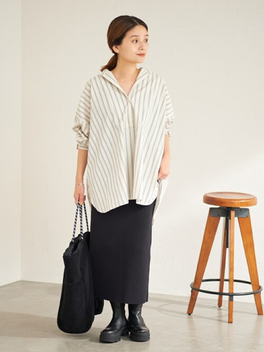 ホワイト系のシャツ/ブラウス、ブラック系のスカート、ブラック系のブーツを着用したレディースの夏コーディネートの1枚目の写真