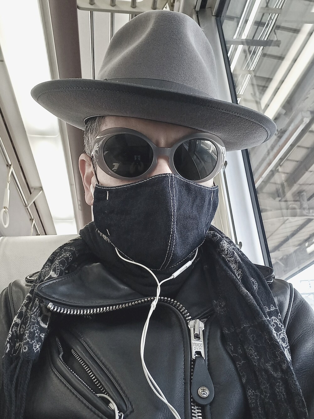 ブラック系のブーツ、ブラック系のライダースジャケット、ブラック系のチノパンツを着用したメンズの春コーディネートの4枚目の写真