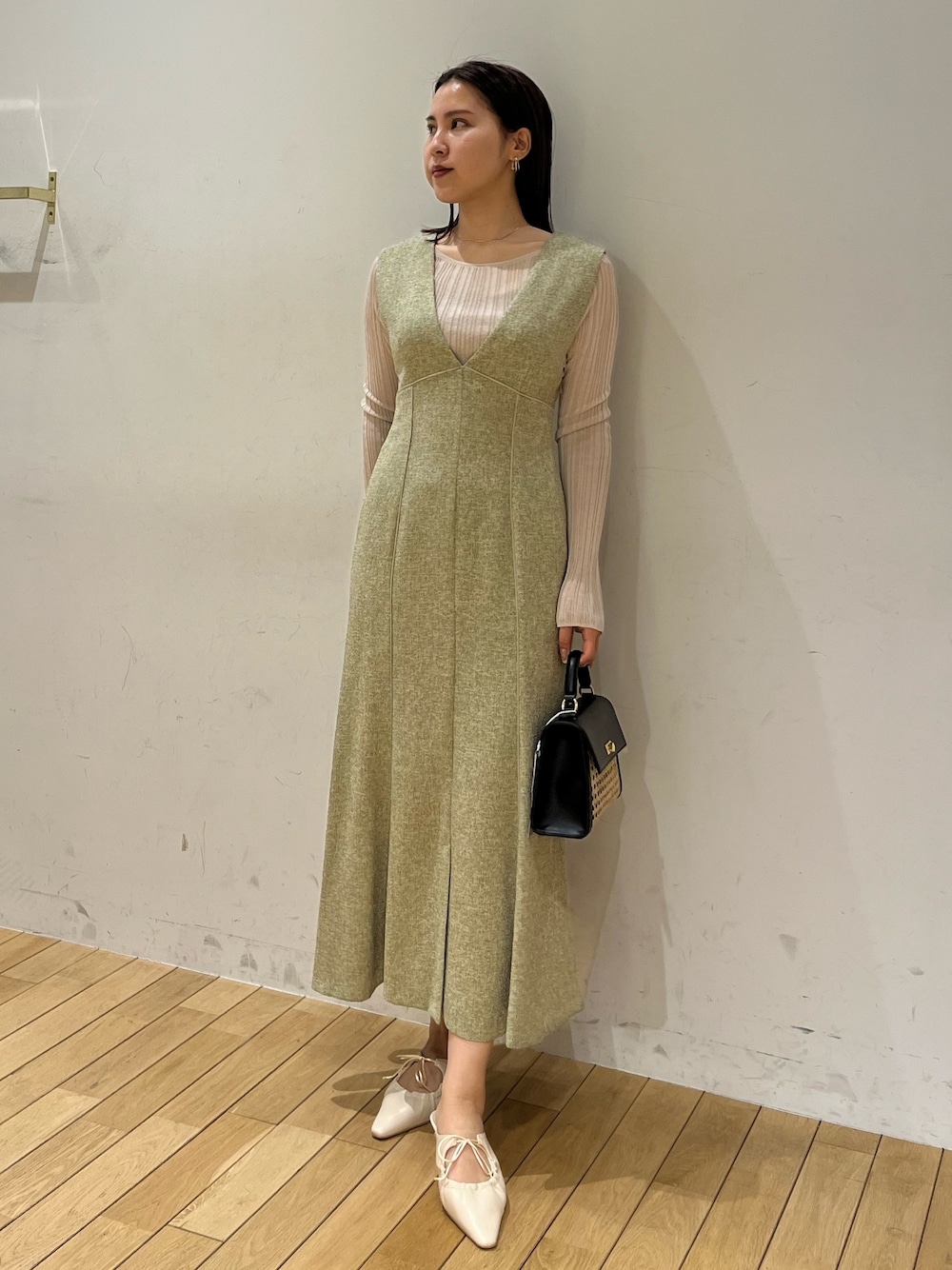 ホワイト系のTシャツ/カットソー、グリーン系のジャンパースカート、ホワイト系のサンダルを着用したレディースの春コーディネートの1枚目の写真