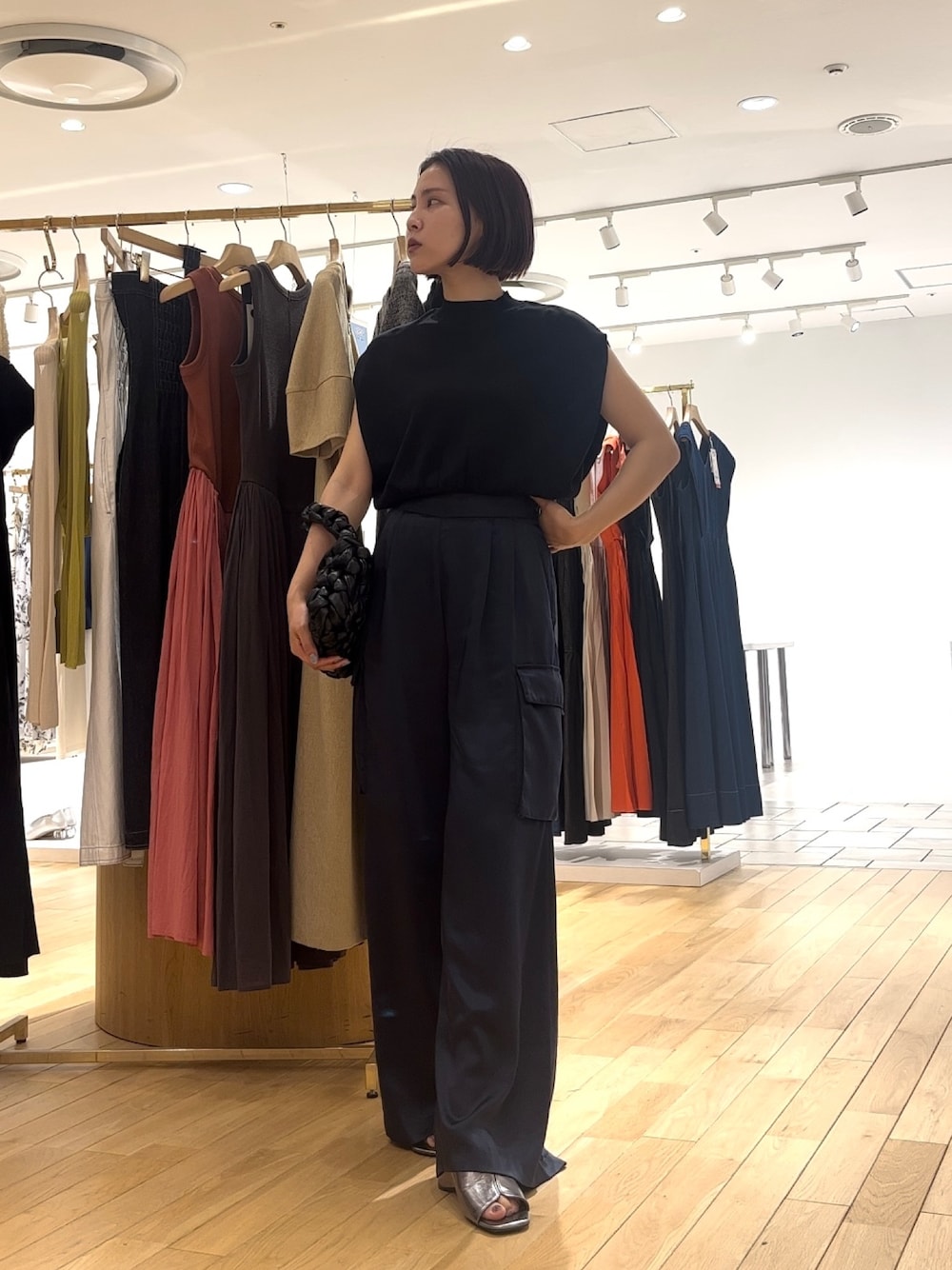 ブルー系のカーゴパンツ、その他のサンダル、ブラック系のハンドバッグを着用したレディースの夏コーディネートの1枚目の写真