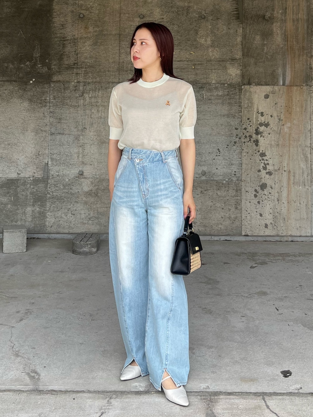 グリーン系のTシャツ/カットソー、ブルー系のデニムパンツ、ブラック系のハンドバッグを着用したレディースの春コーディネートの1枚目の写真