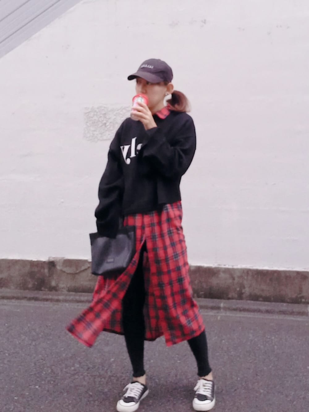 ブラック系のニット/セーター、ブラック系のトートバッグ、ブラック系のスニーカーを着用したレディースの秋コーディネートの1枚目の写真