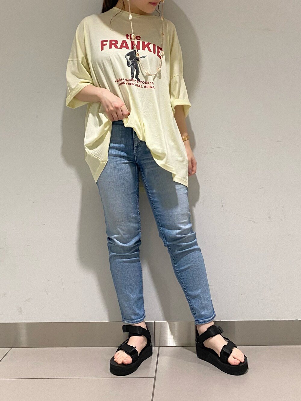 ブルー系のデニムパンツ、イエロー系のTシャツ/カットソー、ブラック系のその他シューズを着用したレディースの春コーディネートの1枚目の写真