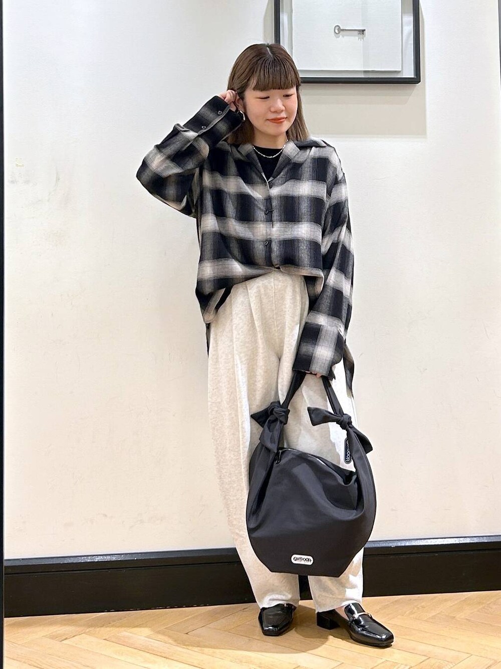 ブラック系のローファー、ブラック系のトートバッグ、グレー系のスウェットパンツを着用したレディースの夏コーディネートの1枚目の写真