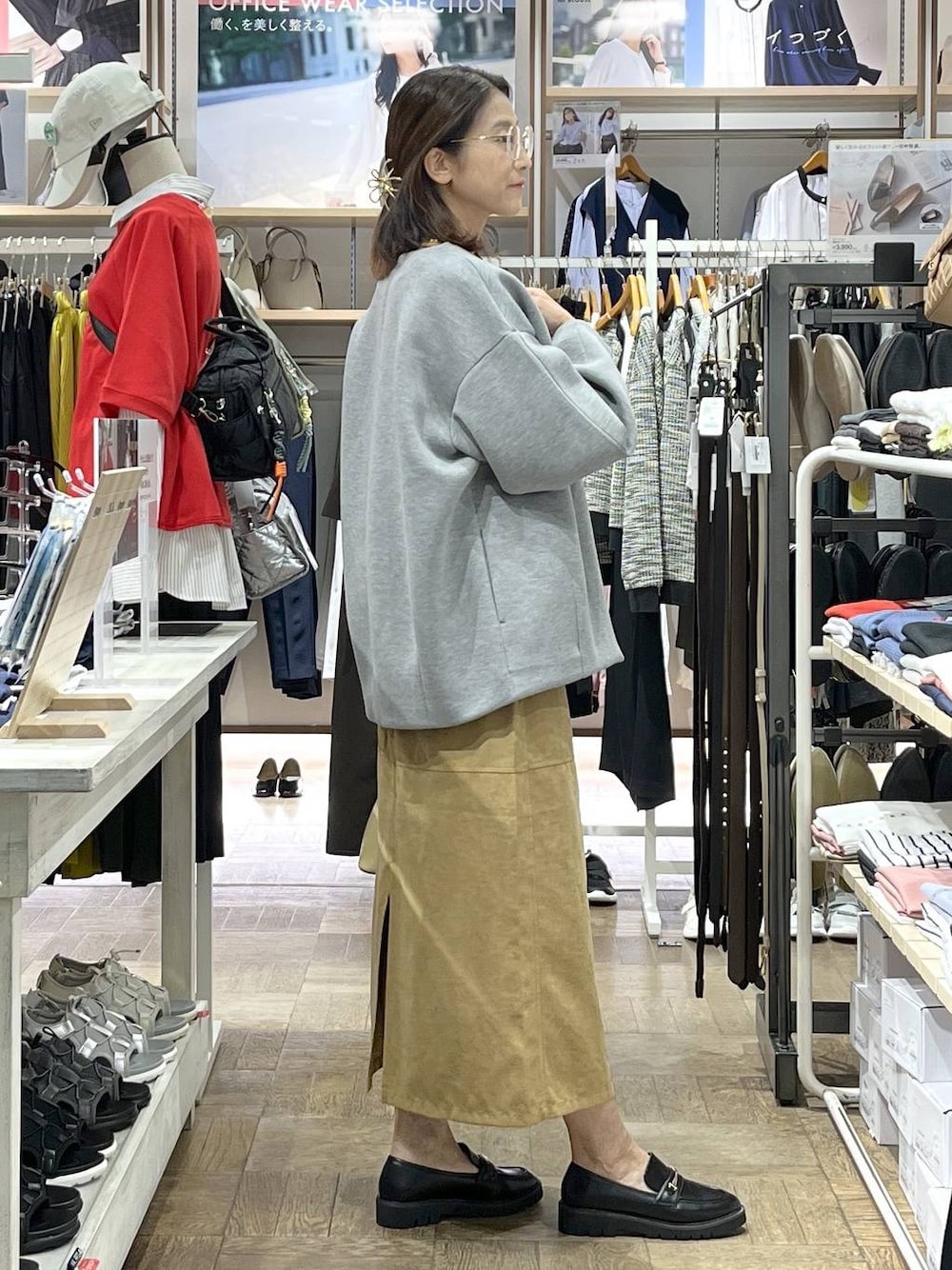 ベージュ系のショルダーバッグ、ブラック系のローファー、グレー系のブルゾンを着用したレディースの秋コーディネートの1枚目の写真