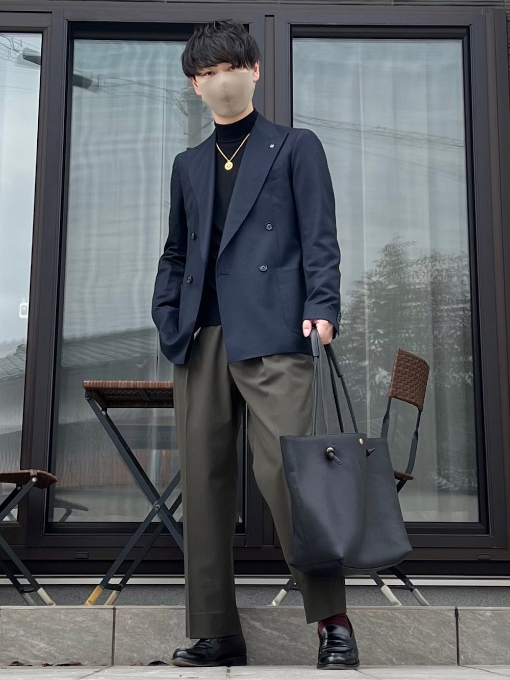 ブラック系のテーラードジャケット、ブラック系のニット/セーター、グリーン系のその他パンツを着用したメンズの春コーディネートの1枚目の写真