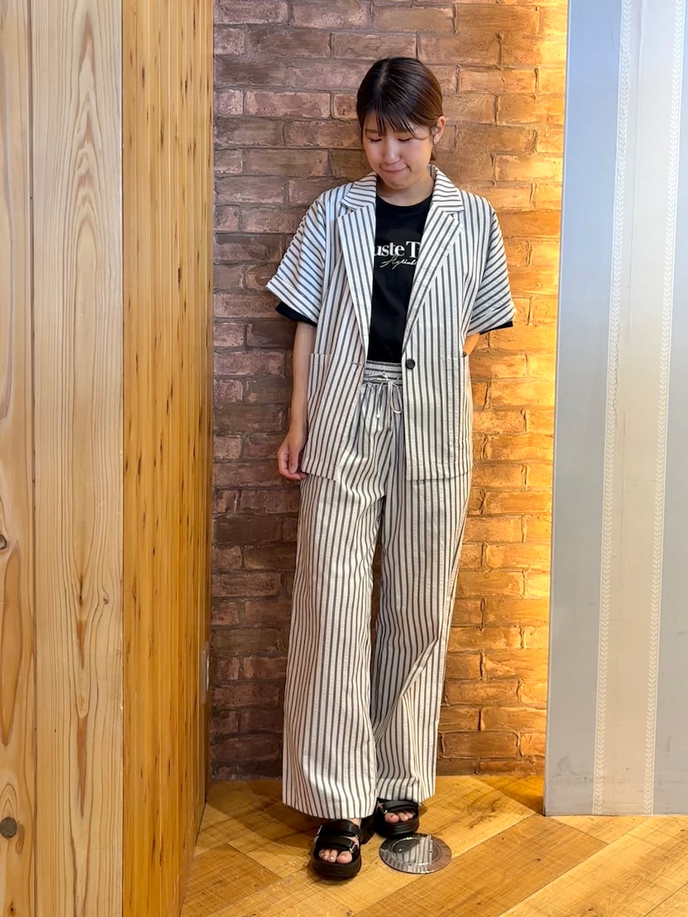 ベージュ系のテーラードジャケット、ブラック系のTシャツ/カットソー、ベージュ系のその他パンツを着用したレディースの夏コーディネートの1枚目の写真