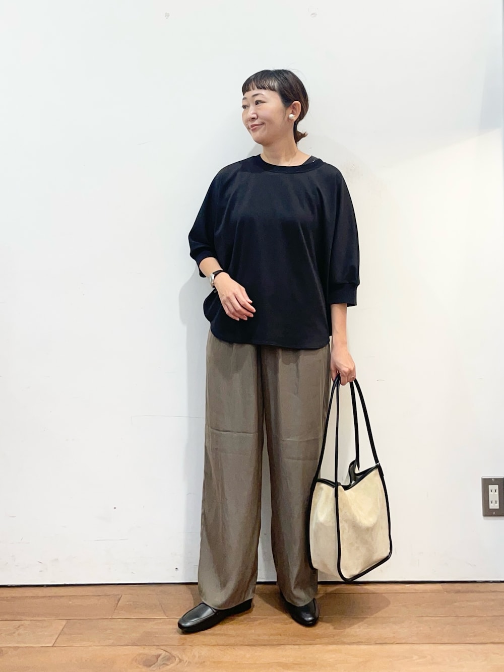 ブラック系のTシャツ/カットソー、ブラウン系のその他パンツ、ベージュ系のトートバッグを着用したレディースの秋コーディネートの1枚目の写真