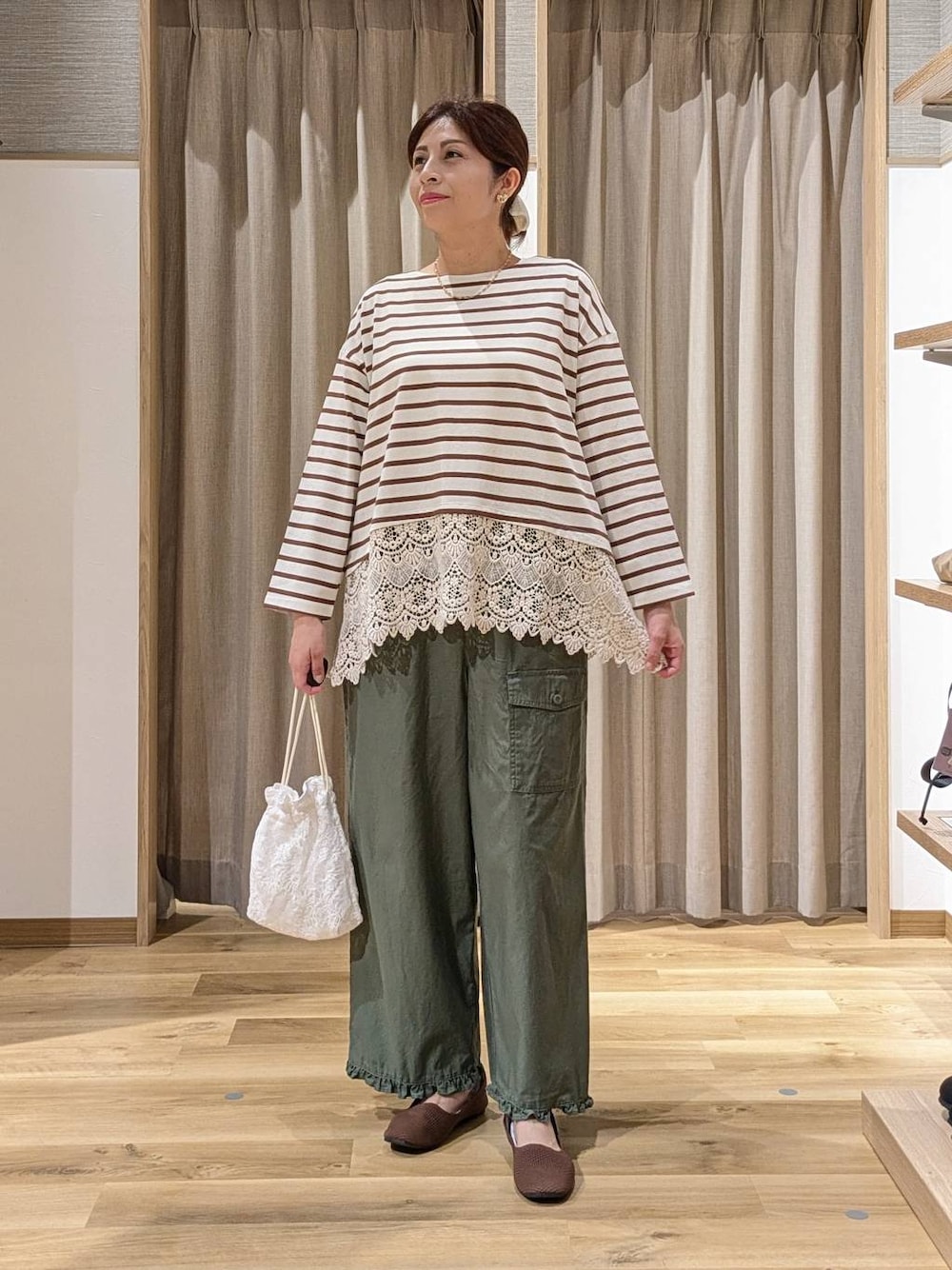 グリーン系のその他パンツ、ホワイト系のTシャツ/カットソー、その他のネックレスを着用したレディースの秋コーディネートの1枚目の写真