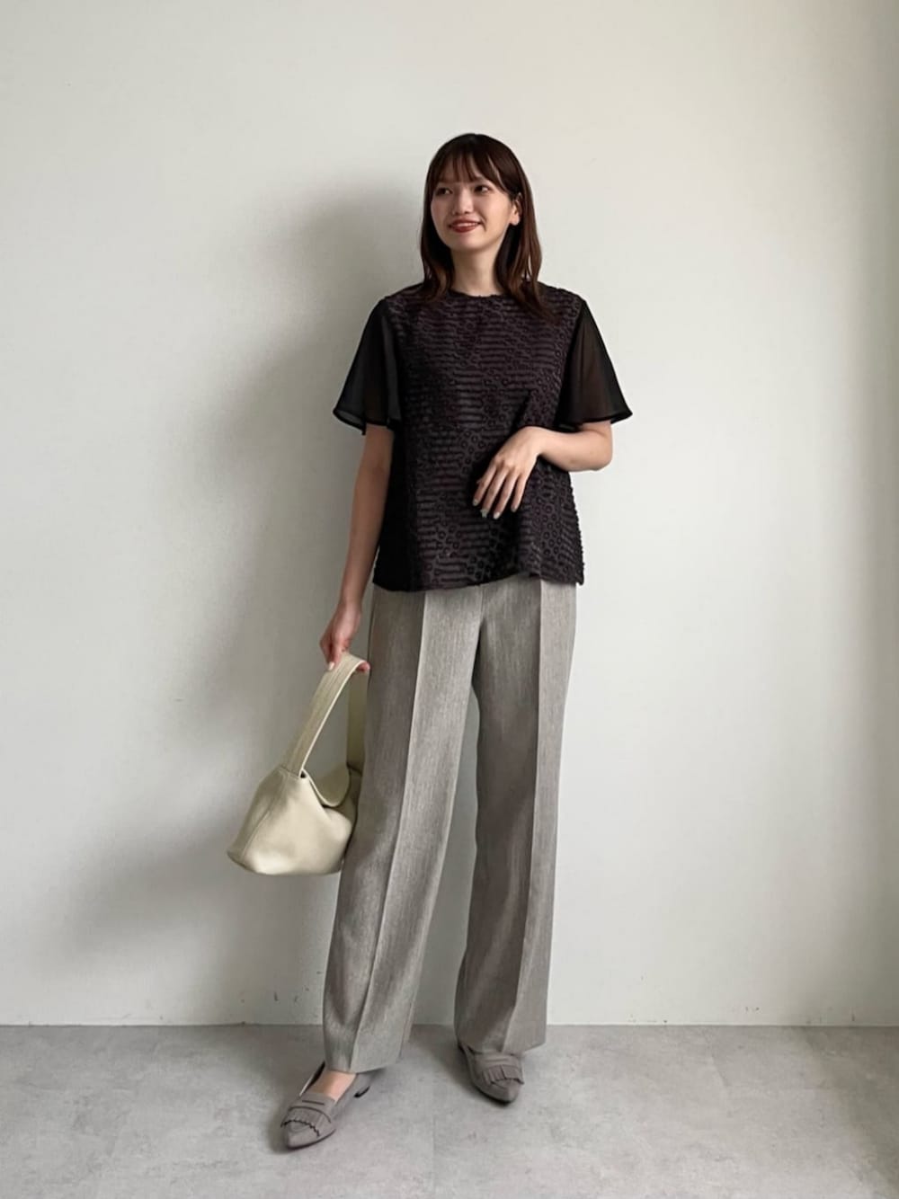 ベージュ系のショルダーバッグ、グレー系のシャツ/ブラウス、ベージュ系のその他パンツを着用したレディースの夏コーディネートの1枚目の写真