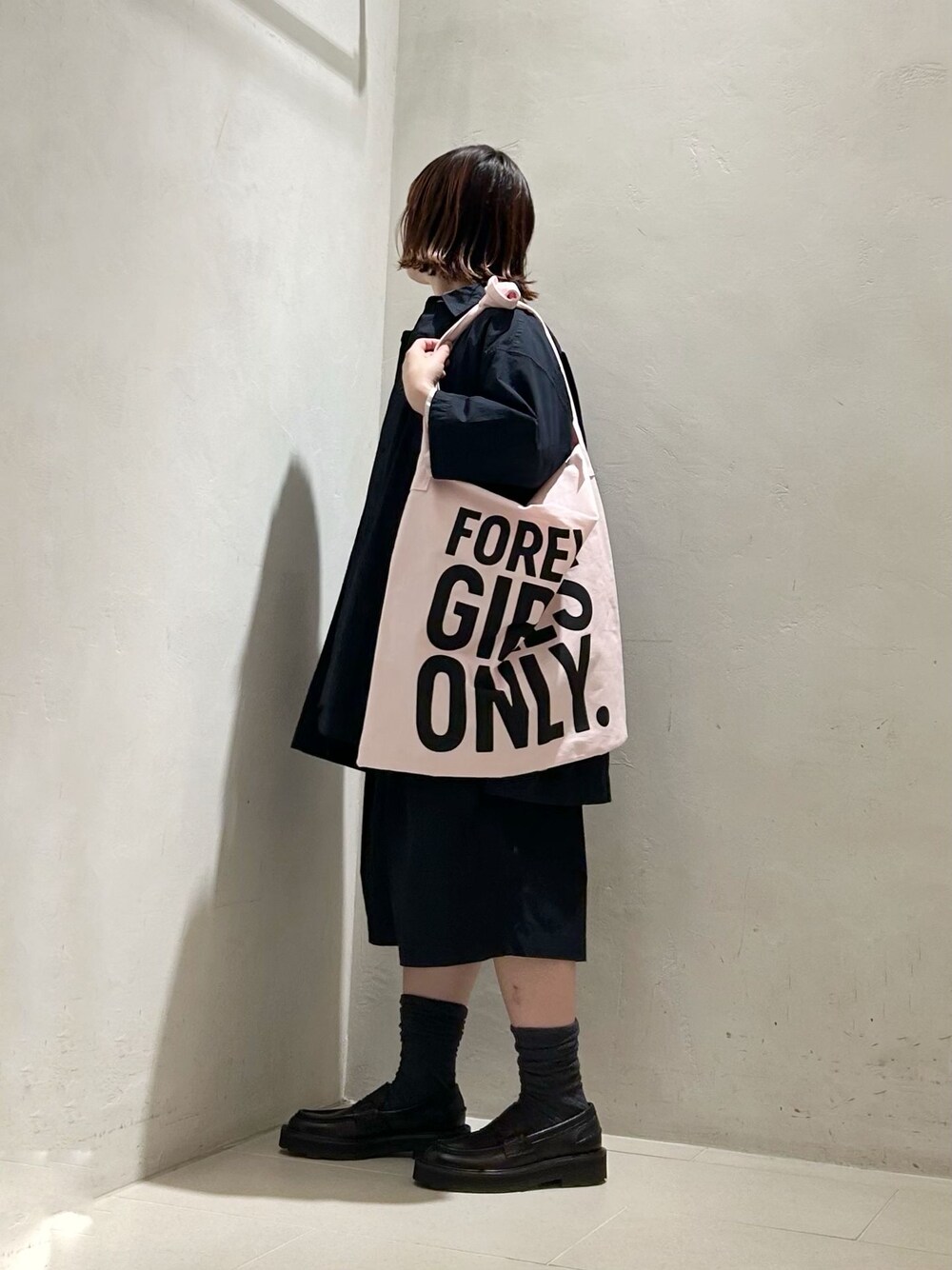 ピンク系のシャツ/ブラウス、ホワイト系のニット/セーター、グレー系のソックス/靴下を着用したレディースの春コーディネートの1枚目の写真
