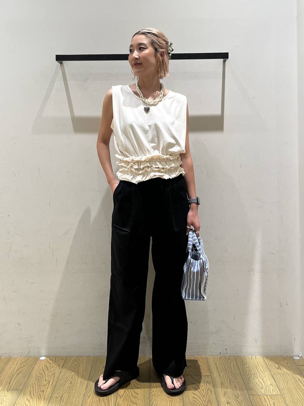 ホワイト系のTシャツ/カットソー、ブルー系のトートバッグ、ブラック系のチノパンツを着用したレディースの夏コーディネートの1枚目の写真