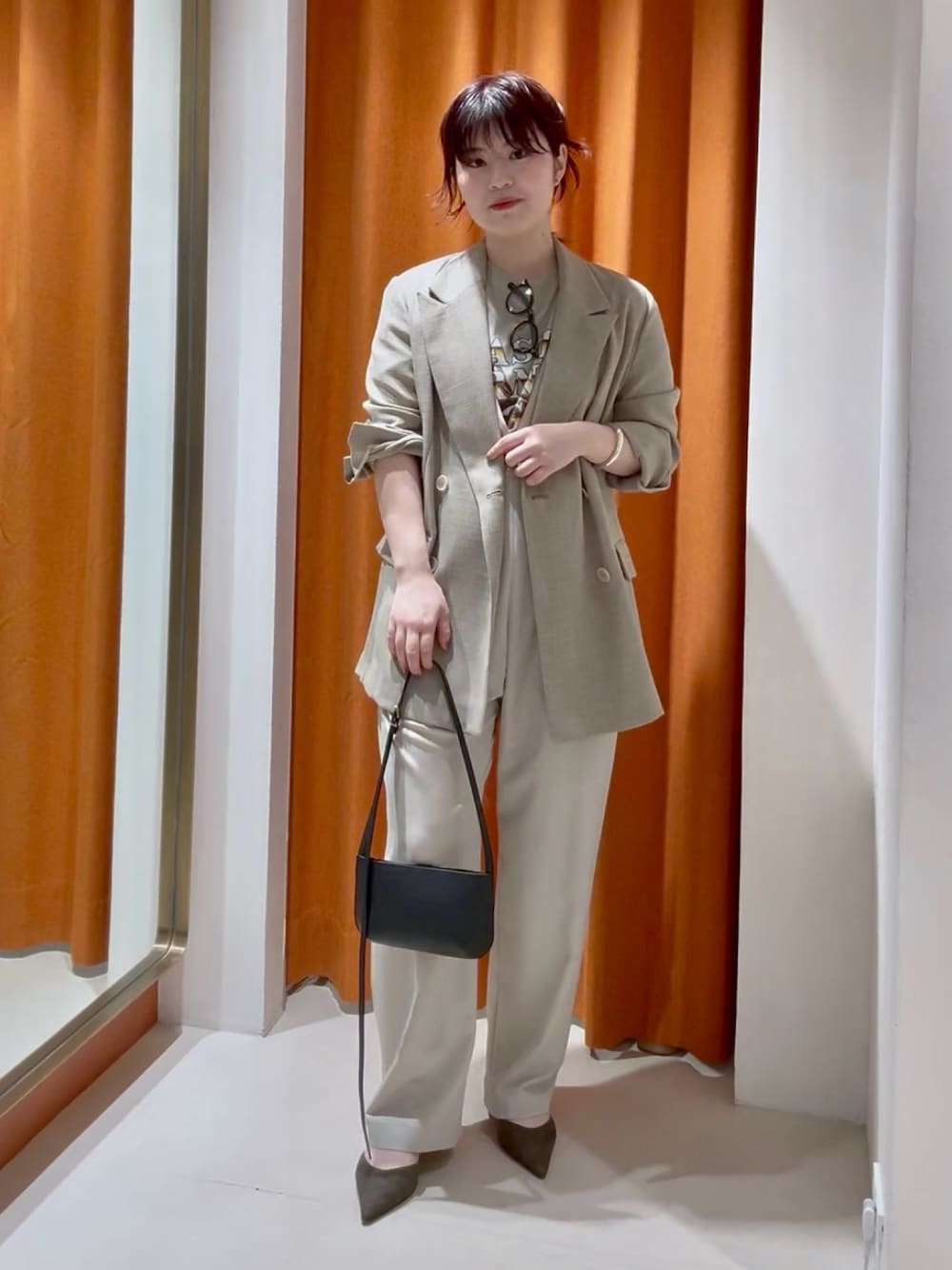 ベージュ系のテーラードジャケット、ベージュ系のつなぎ/オールインワン、ブラウン系のパンプスを着用したレディースの春コーディネートの1枚目の写真