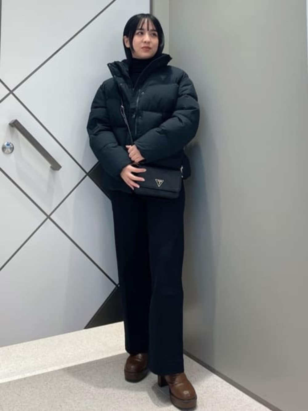 「guess、GUESS、ダウンジャケット、ブラック、ブラックコーデ、カジュアル、カジュアルコーデ」｜「GuessのNOELLE Crossbody Flap Organizer（ショルダーバッグ、ブラック系）」を使った、GUESS JAPANさん（レディース・159cm）の冬コーディネートの1枚目の写真