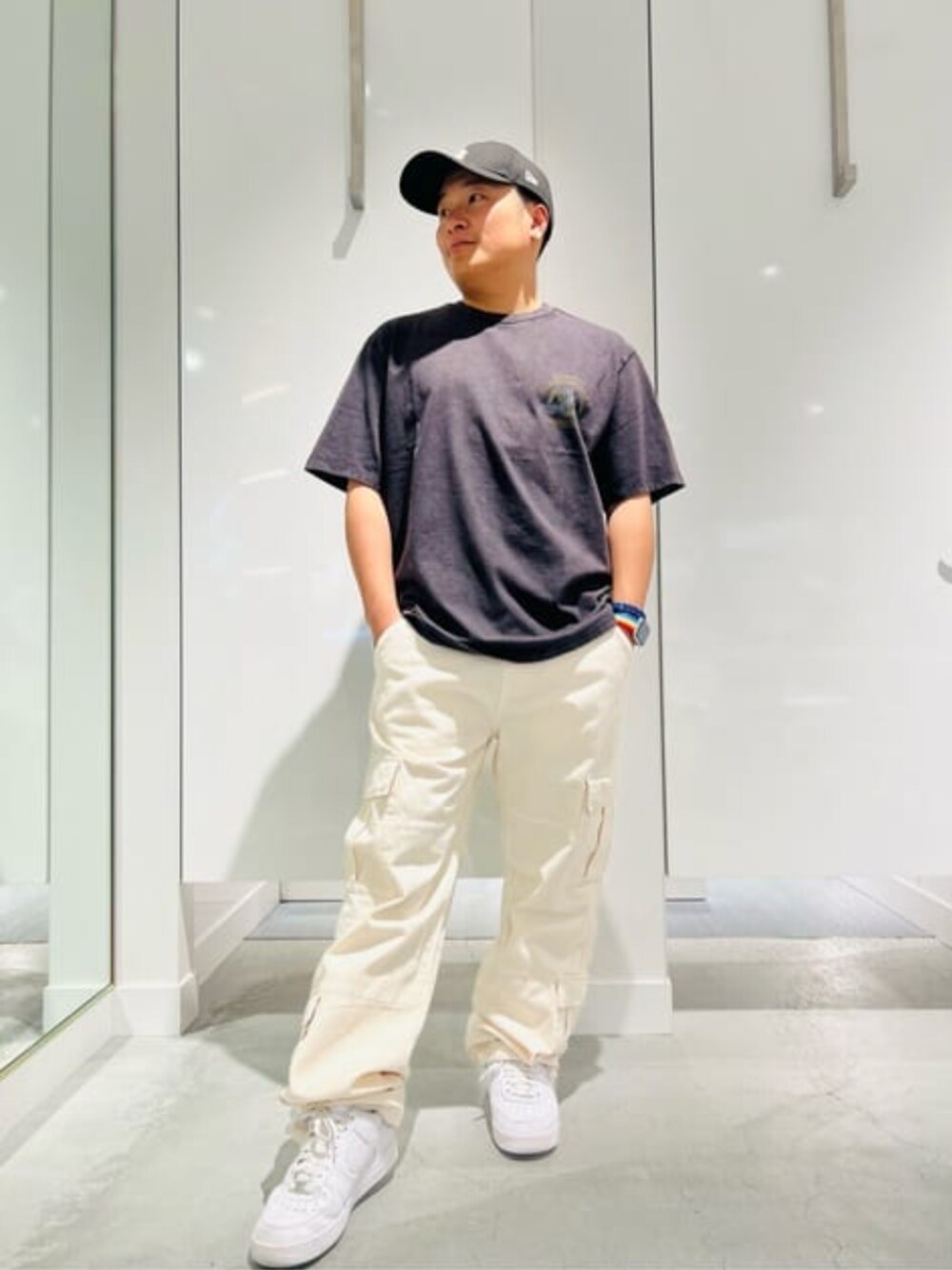 ホワイト系のカーゴパンツ、ブラック系のTシャツ/カットソーを着用したメンズの春コーディネートの1枚目の写真