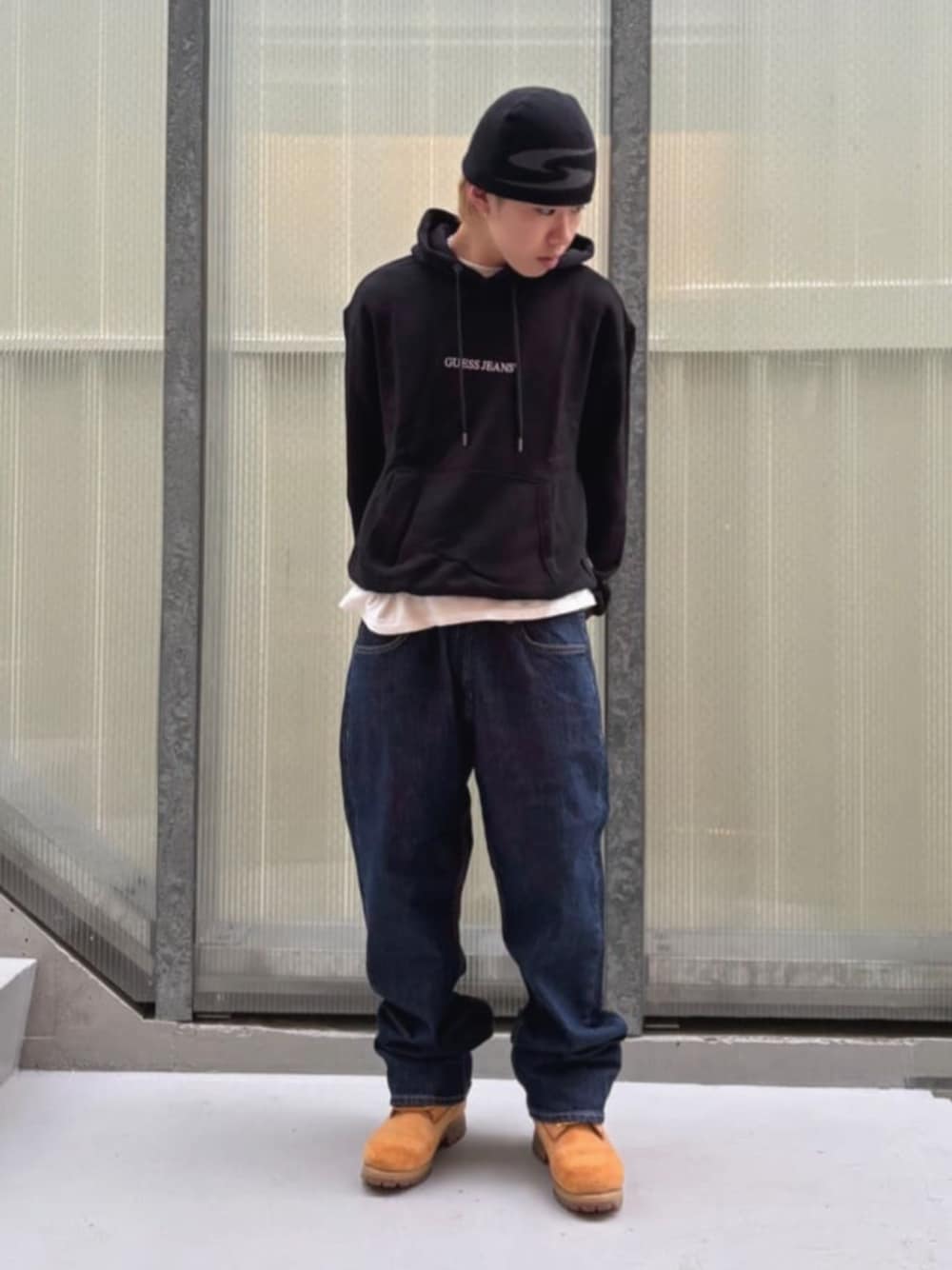 ブルー系のデニムパンツ、ホワイト系のTシャツ/カットソー、ブラック系のパーカーを着用したメンズの秋コーディネートの1枚目の写真