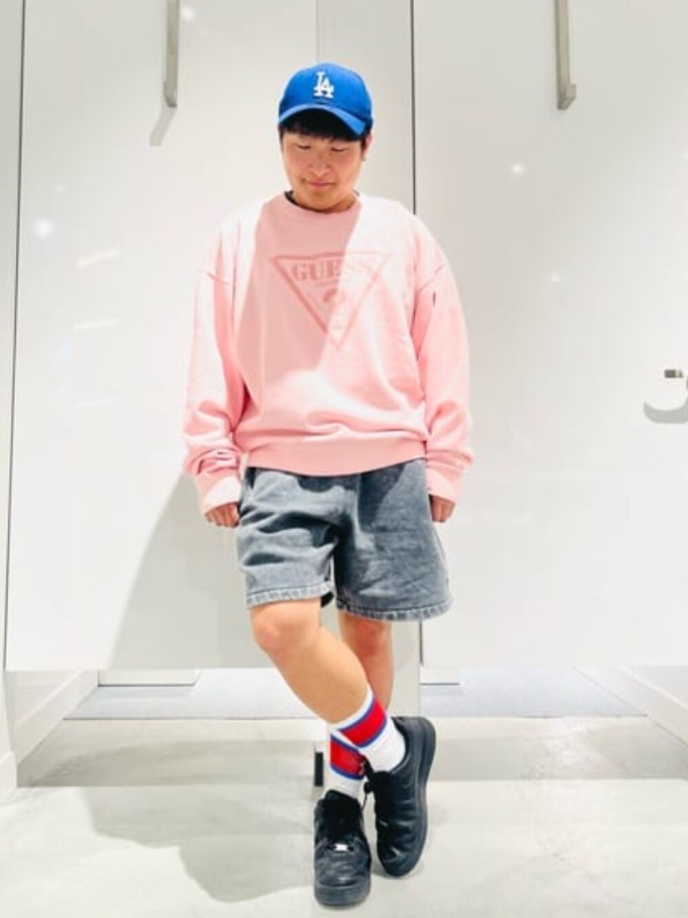 ピンク系のスウェット、ブラック系のデニムパンツを着用したメンズの春コーディネートの1枚目の写真