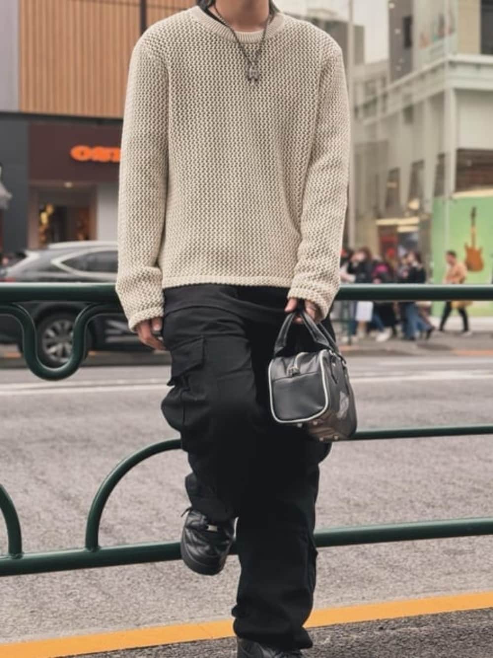 ブラック系のカーゴパンツ、ブラック系のハンドバッグ、ブラック系のTシャツ/カットソーを着用したメンズの春コーディネートの1枚目の写真