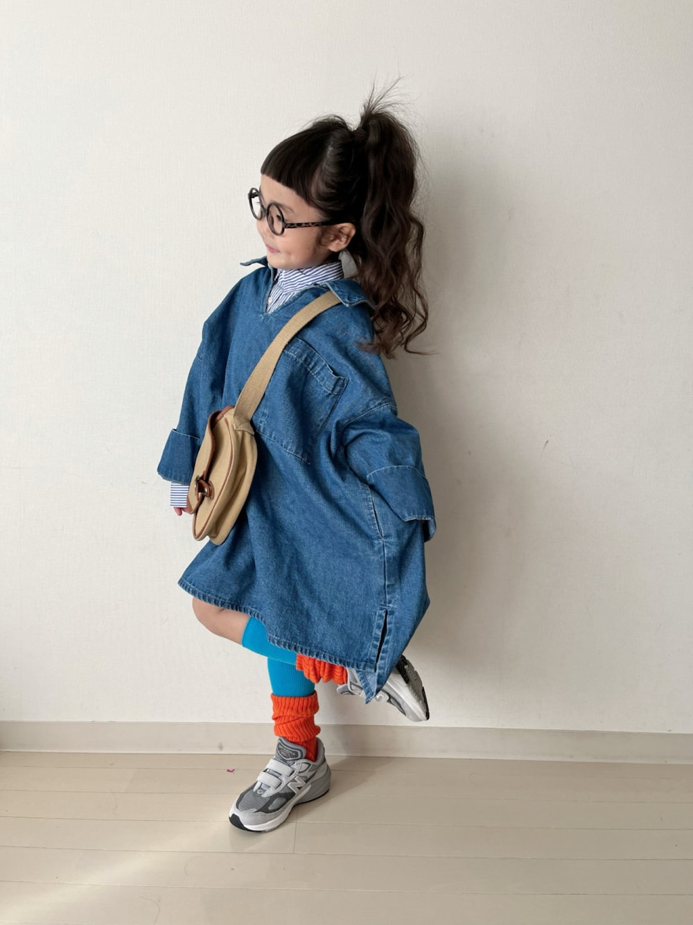 ブルー系のワンピース、ブルー系のシャツ/ブラウス、ベージュ系のショルダーバッグを着用したキッズの冬コーディネートの1枚目の写真