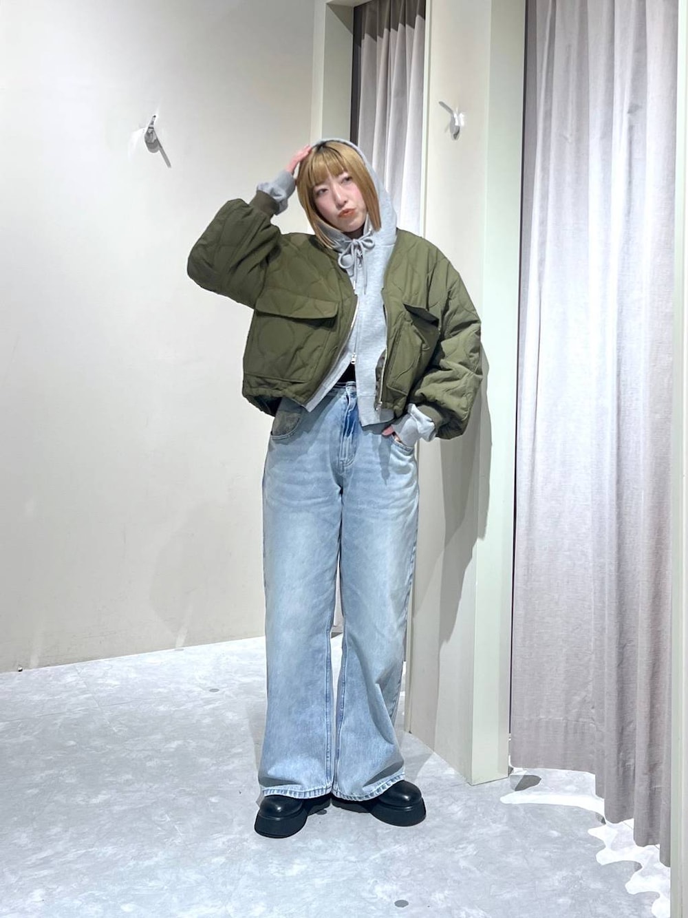 ブラック系のサンダル、グリーン系のブルゾン、グレー系のパーカーを着用したレディースの冬コーディネートの1枚目の写真