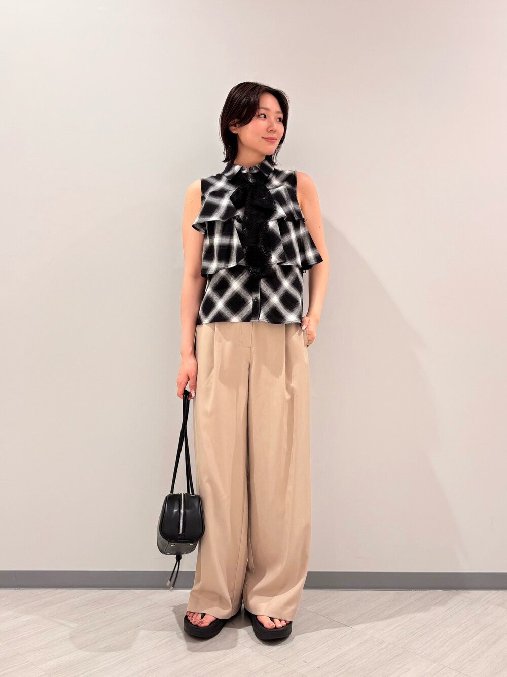 ブラック系のシャツ/ブラウス、ベージュ系のその他パンツ、ブラック系のボストンバッグを着用したレディースの夏コーディネートの1枚目の写真