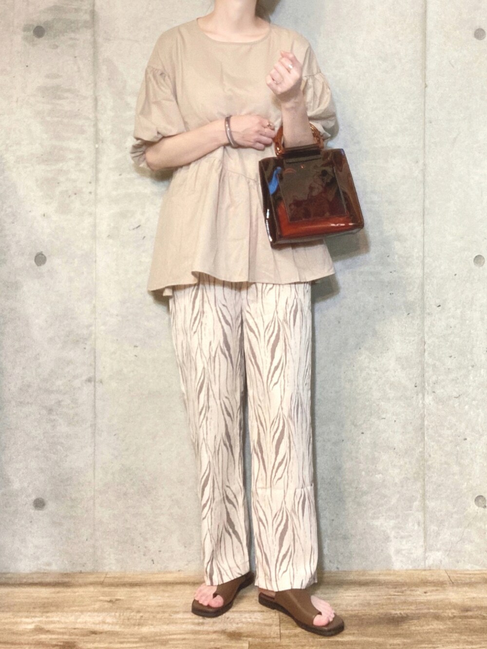ベージュ系のシャツ/ブラウス、ブラウン系のハンドバッグ、ベージュ系のその他パンツを着用したレディースの夏コーディネートの1枚目の写真