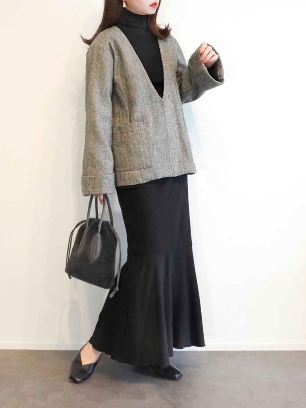 ブラック系のノーカラージャケット、グレー系のショルダーバッグ、ブラック系のパンプスを着用したレディースの秋コーディネートの1枚目の写真