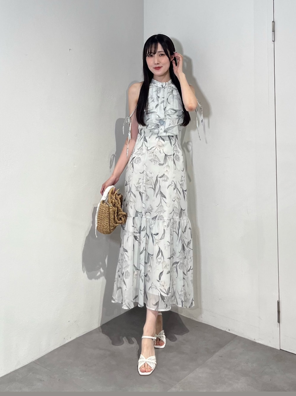 ブルー系のワンピース、ベージュ系のハンドバッグ、ホワイト系のサンダルを着用したレディースの夏コーディネートの1枚目の写真