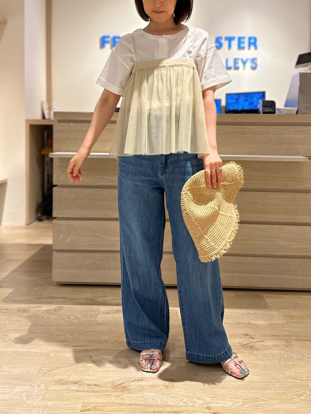 ブルー系のデニムパンツ、ホワイト系のTシャツ/カットソー、ベージュ系のシャツ/ブラウスを着用したレディースの夏コーディネートの1枚目の写真