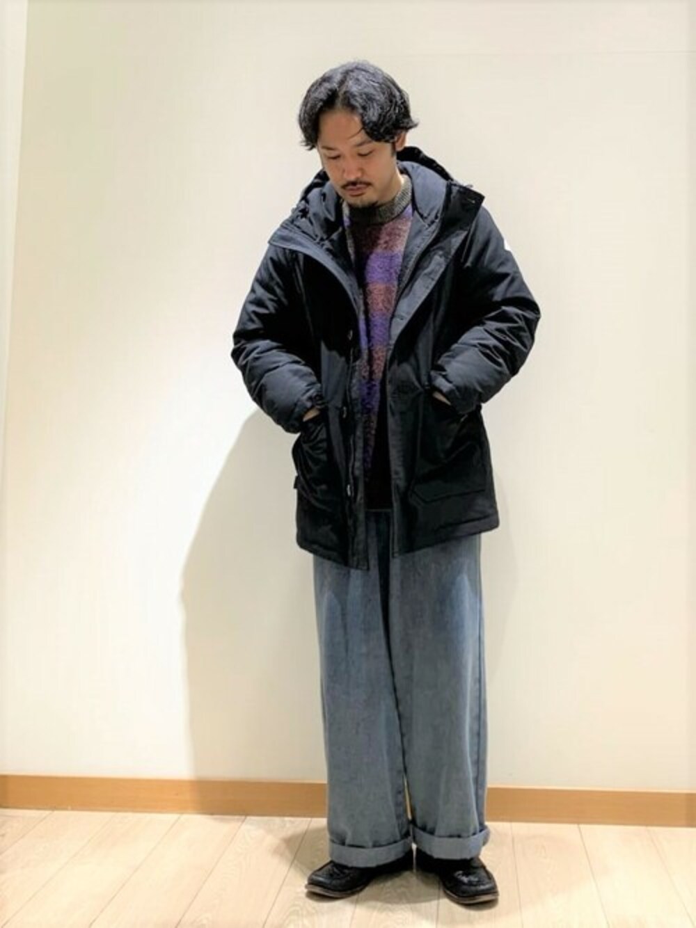 ブラック系のダウンジャケット/コート、パープル系のニット/セーターを着用したメンズの冬コーディネートの1枚目の写真