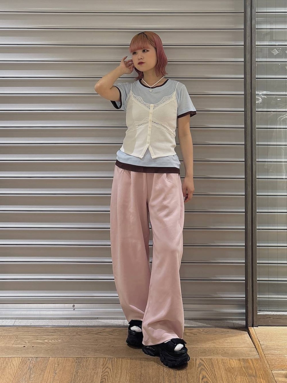 ピンク系のスウェットパンツ、ブラック系のサンダル、ホワイト系のキャミソールを着用したレディースの春コーディネートの1枚目の写真