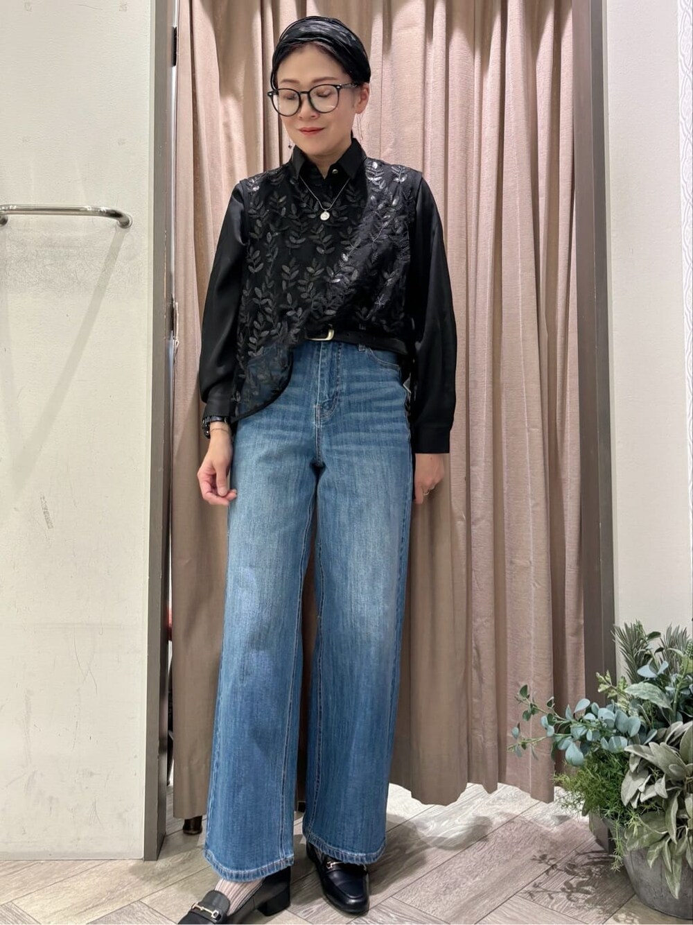 ブラック系のシャツ/ブラウス、ブルー系のデニムパンツ、ブラック系のベルトを着用したレディースの秋コーディネートの1枚目の写真