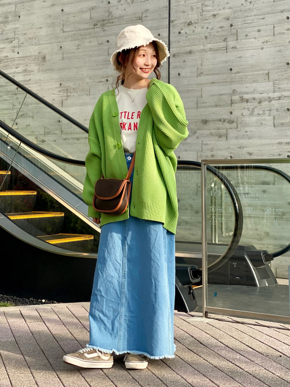 ホワイト系のTシャツ/カットソー、グリーン系のカーディガン/ボレロ、ブラウン系のショルダーバッグを着用したレディースの冬コーディネートの1枚目の写真