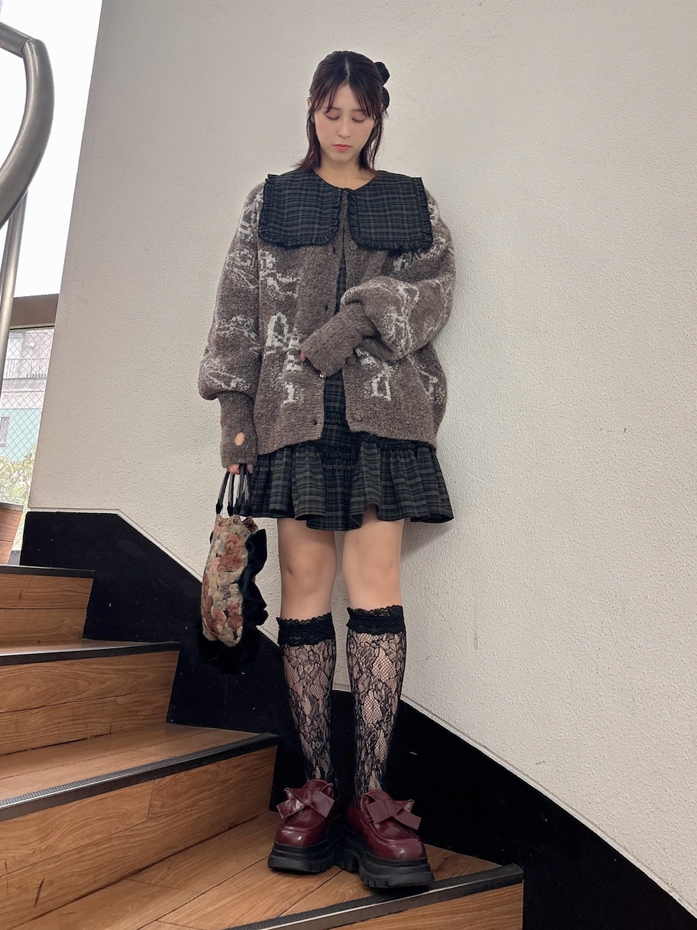 グリーン系のワンピース、ブラウン系のカーディガン/ボレロ、レッド系のローファーを着用したレディースの秋コーディネートの1枚目の写真