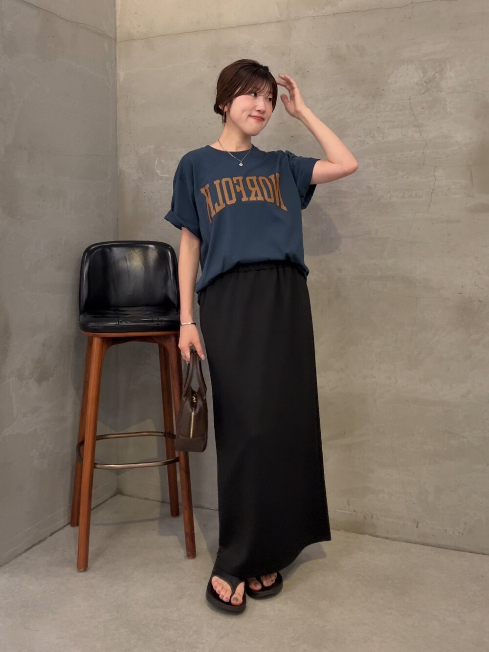 ブルー系のTシャツ/カットソー、ブラック系のスカート、ブラウン系のショルダーバッグを着用したレディースの夏コーディネートの1枚目の写真