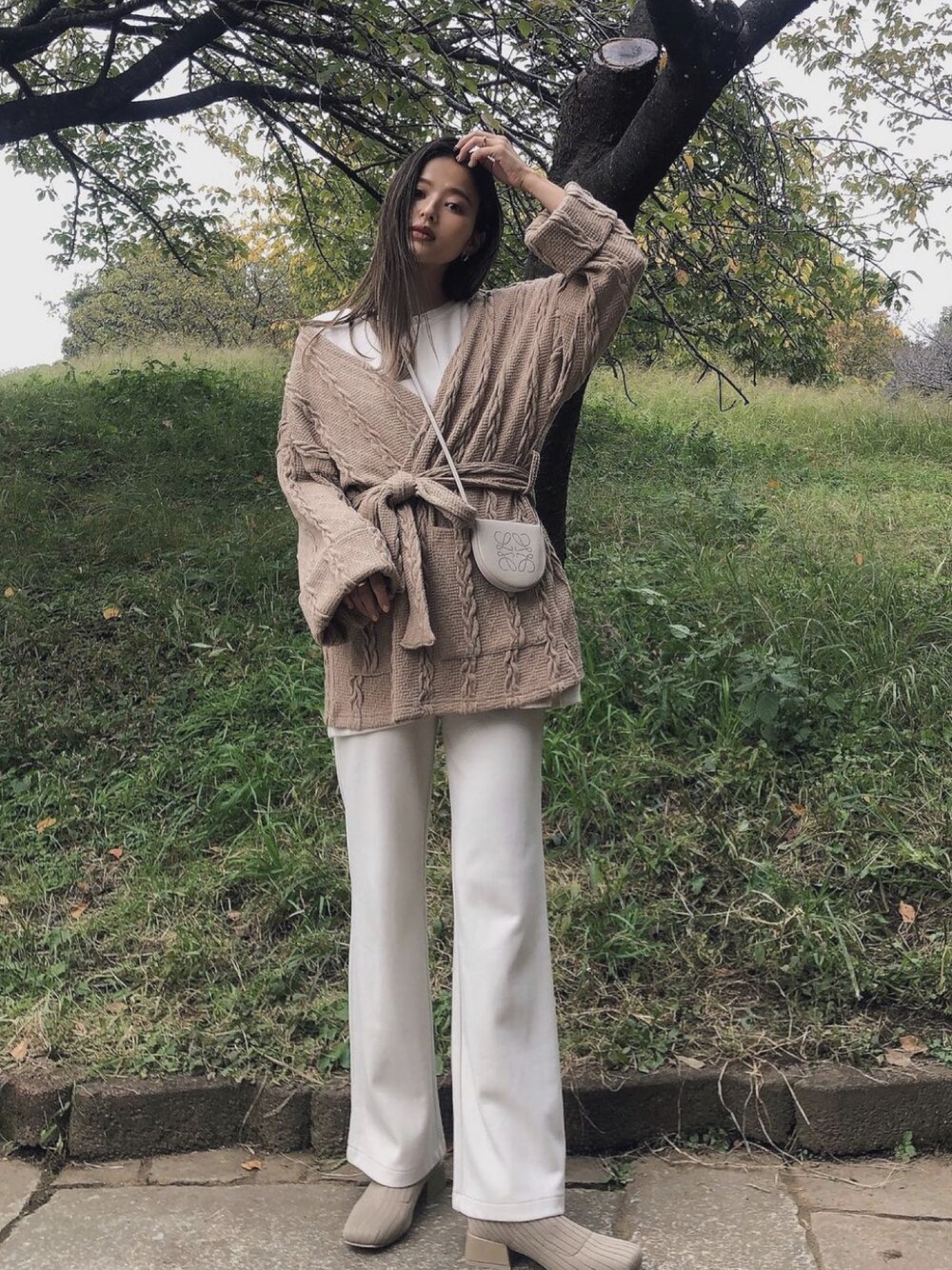 ベージュ系のブーツ、ベージュ系のカーディガン/ボレロを着用したレディースの冬コーディネートの1枚目の写真