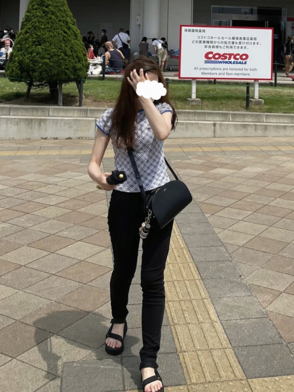 ブラック系のデニムパンツ、ブラック系のサンダル、ブルー系のTシャツ/カットソーを着用したレディースの夏コーディネートの1枚目の写真