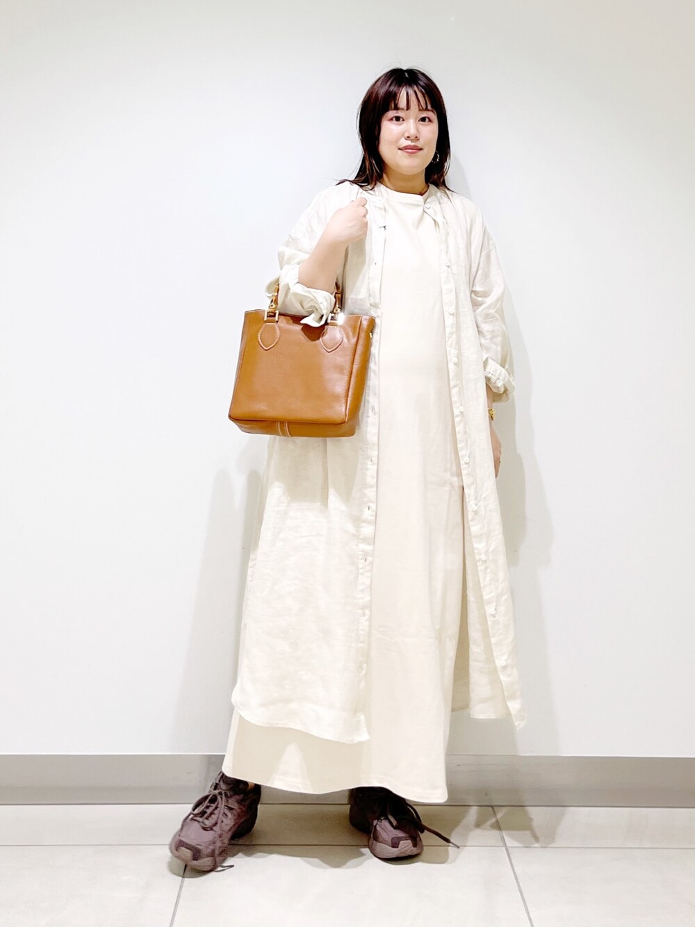 ベージュ系のワンピース、ベージュ系のワンピース、ブラウン系のトートバッグを着用したレディースの夏コーディネートの1枚目の写真