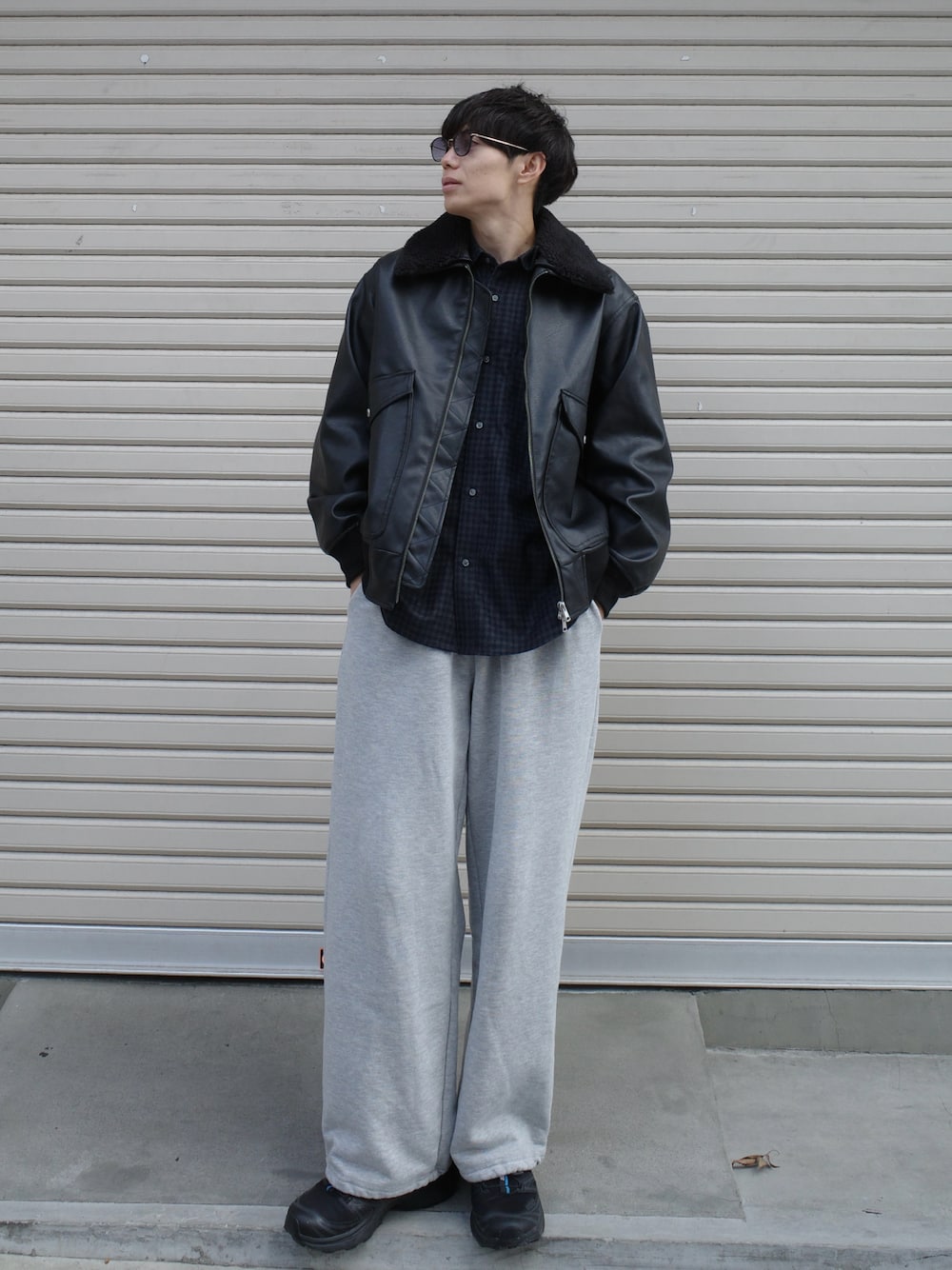 ブラック系のブルゾン、グレー系のスウェットパンツ、ブラック系のスニーカーを着用したメンズの秋コーディネートの1枚目の写真