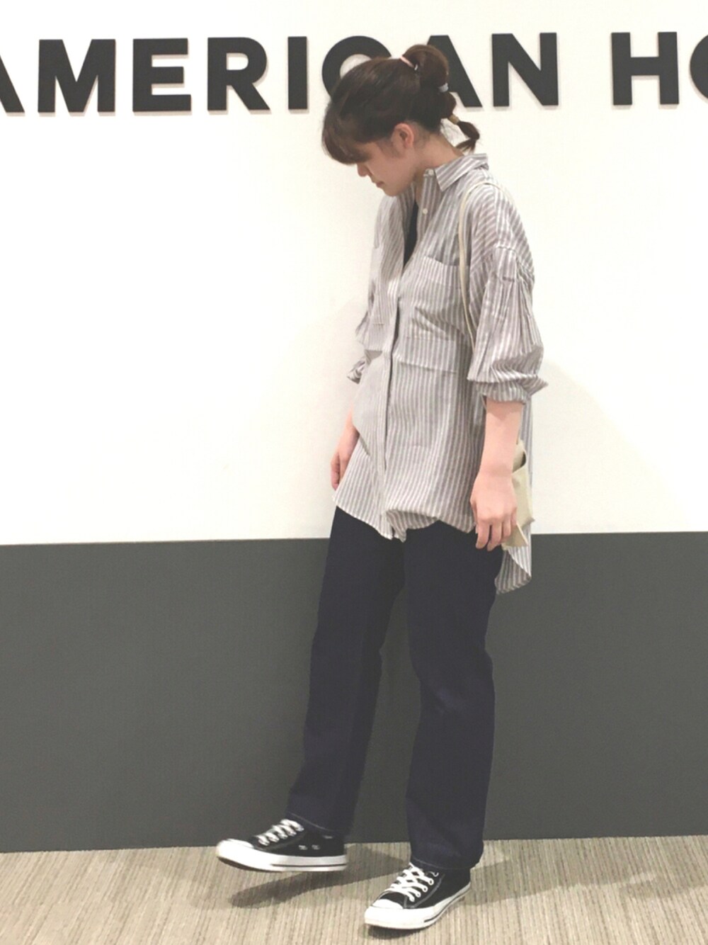 ホワイト系のショルダーバッグ、その他のTシャツ/カットソー、ブラック系のスニーカーを着用したレディースの秋コーディネートの1枚目の写真