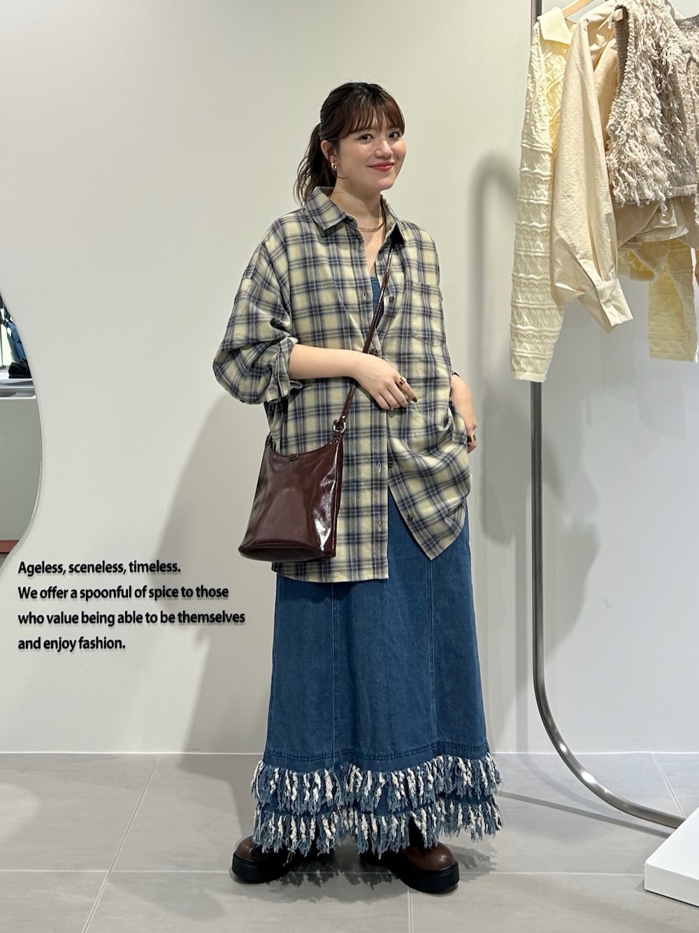 ブルー系のワンピース、イエロー系のシャツ/ブラウス、ブラウン系のショルダーバッグを着用したレディースの秋コーディネートの1枚目の写真