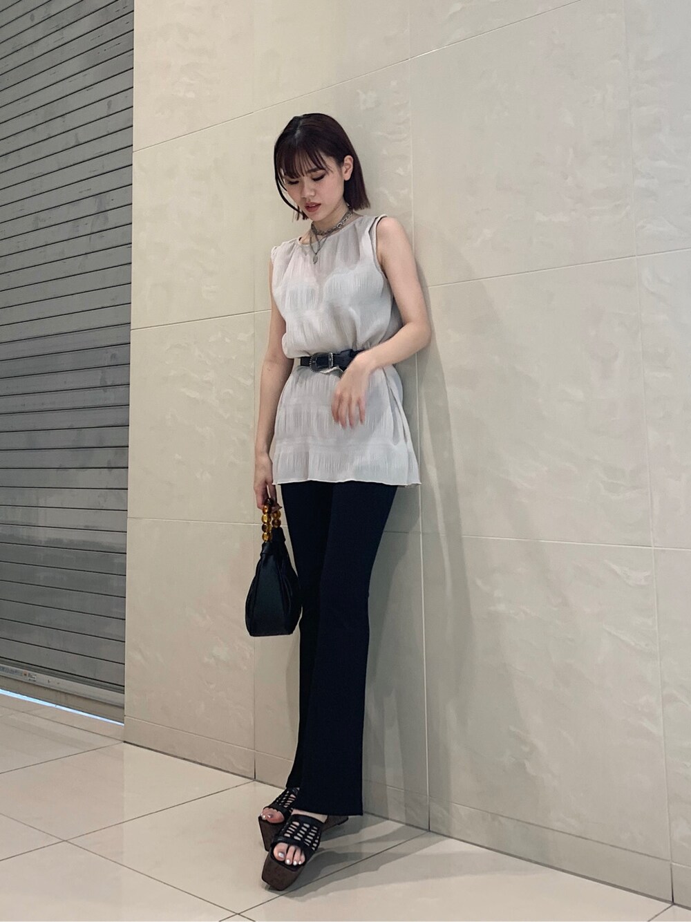 ホワイト系のTシャツ/カットソー、ブラック系のその他パンツ、ブラック系のハンドバッグを着用したレディースの春コーディネートの1枚目の写真