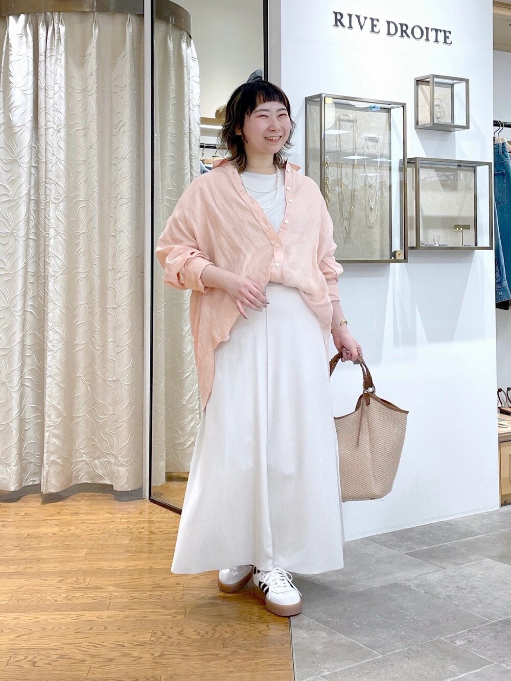 ホワイト系のTシャツ/カットソー、ピンク系のシャツ/ブラウス、ホワイト系のスカートを着用したレディースの春コーディネートの1枚目の写真