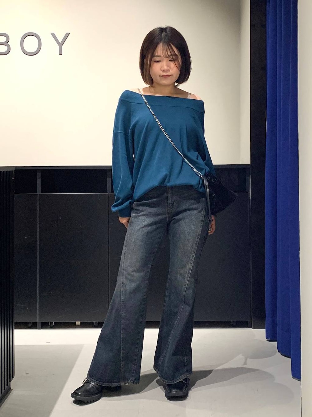 ホワイト系のキャミソール、ブルー系のデニムパンツ、グリーン系のニット/セーターを着用したレディースの秋コーディネートの1枚目の写真