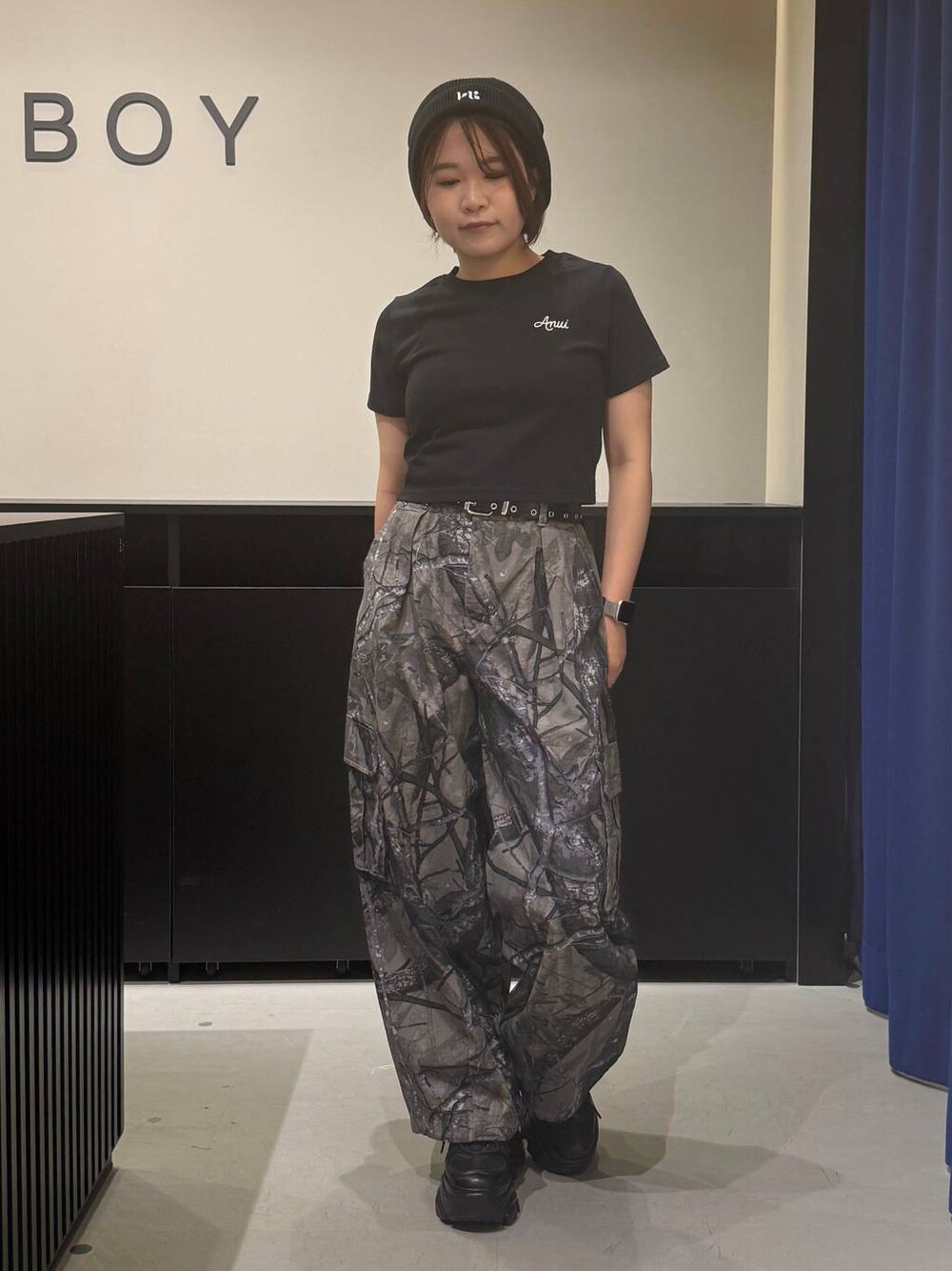 ブラック系のスニーカー、グレー系のカーゴパンツ、ブラック系のTシャツ/カットソーを着用したレディースの夏コーディネートの1枚目の写真